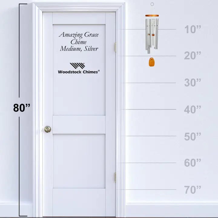 wind chime beside a white door with measurements