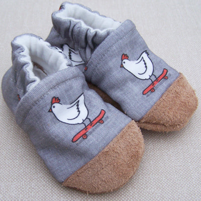snow and arrow skater chicken shoes on a cream background