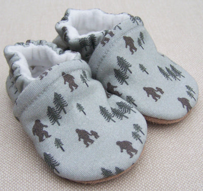 baby slippers on a tan background