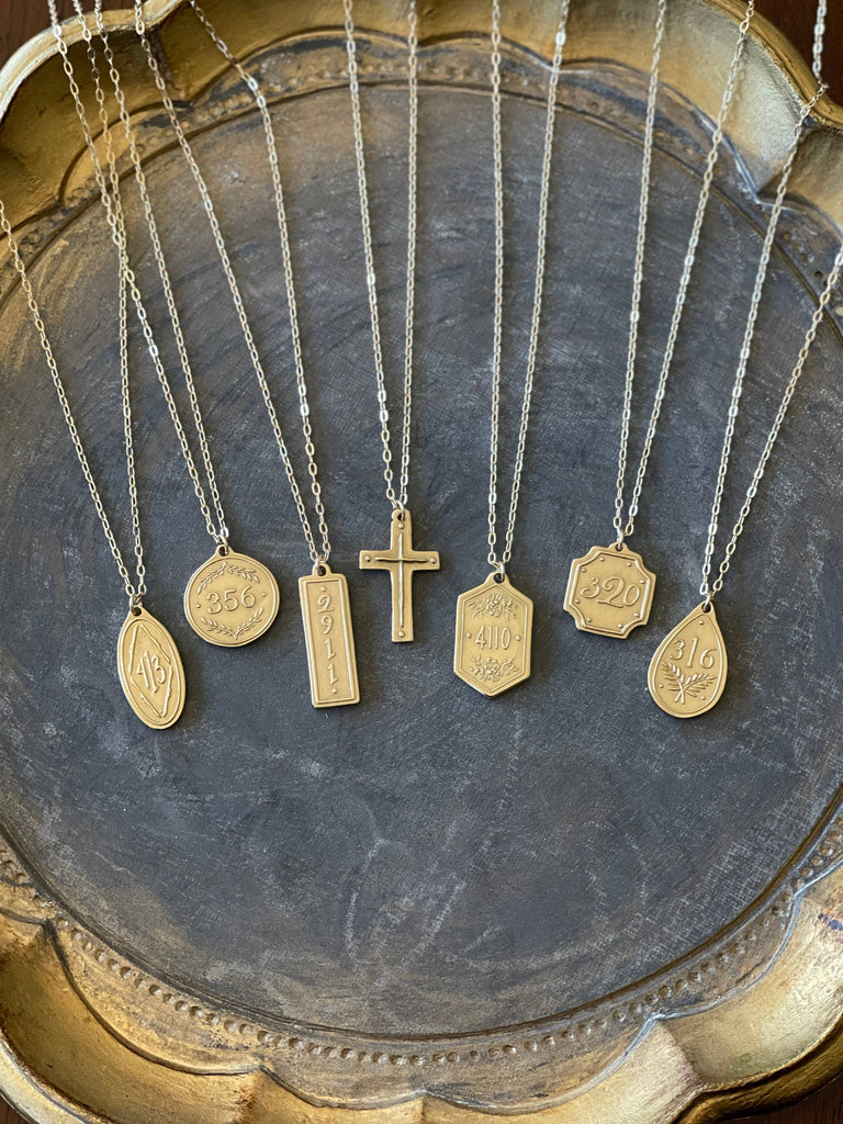 multiple necklaces on a gray tray