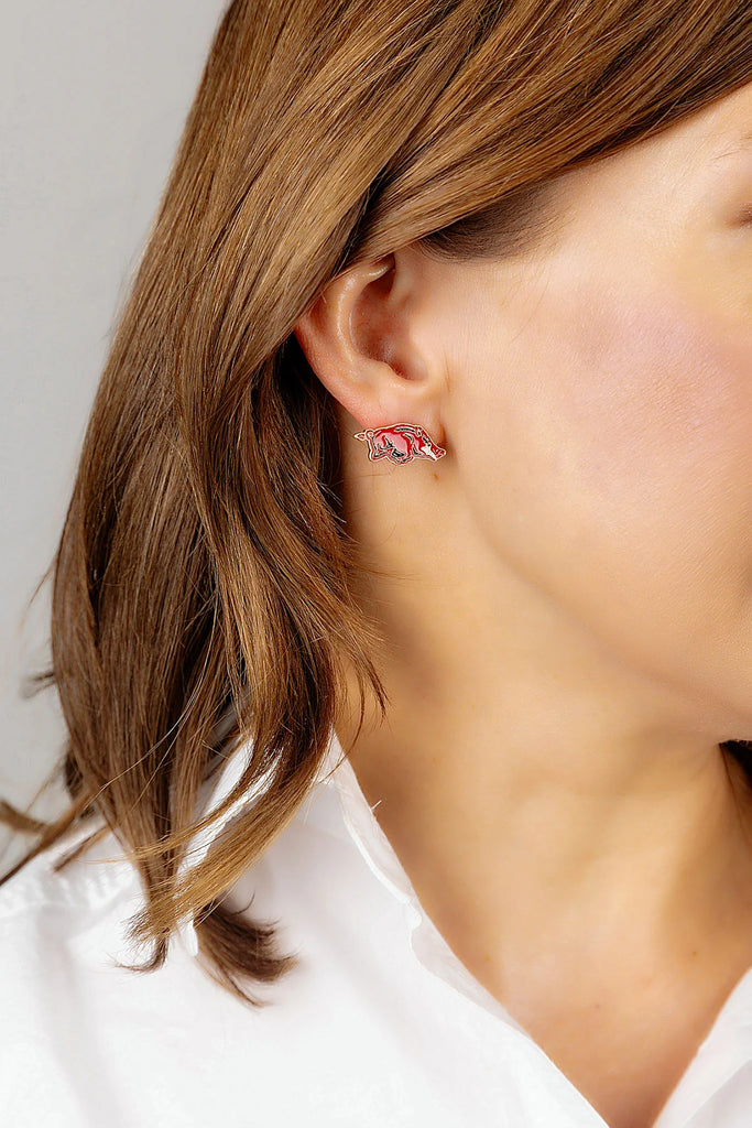 arkansas razorbacks stud earrings being worn on a white background