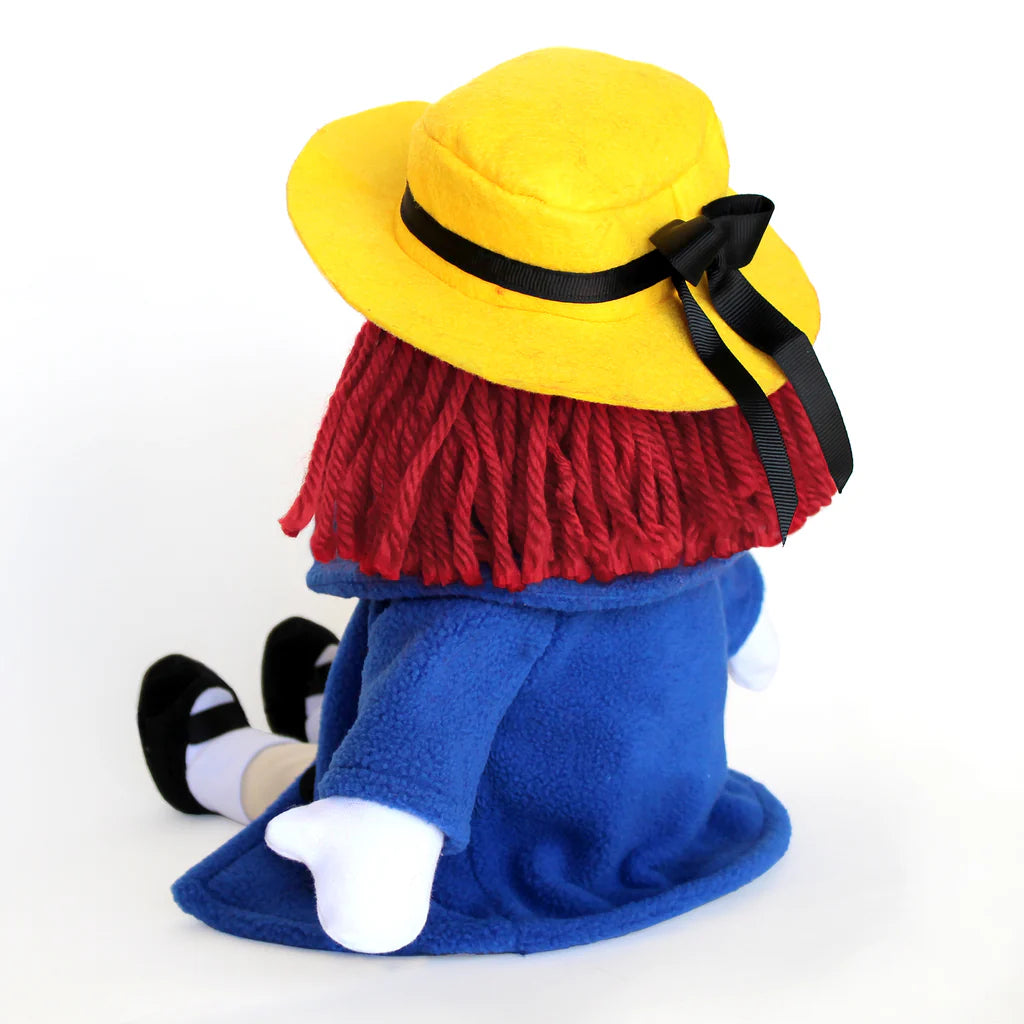 Plush toy with a yellow hat, red scarf, and blue outfit on a white background