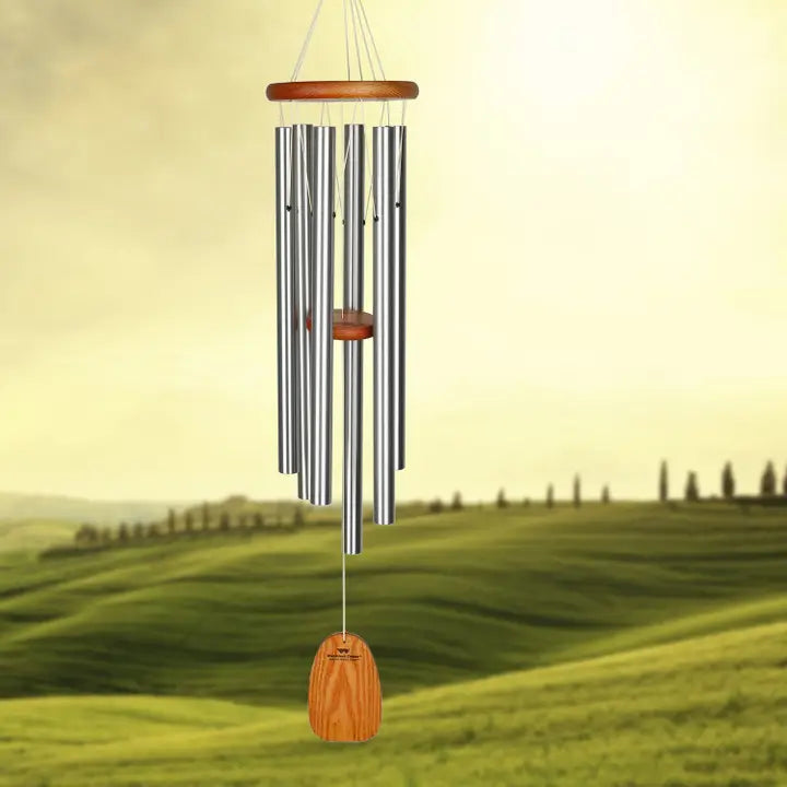 amazing grace wind chime with a rolling hill green field in the background