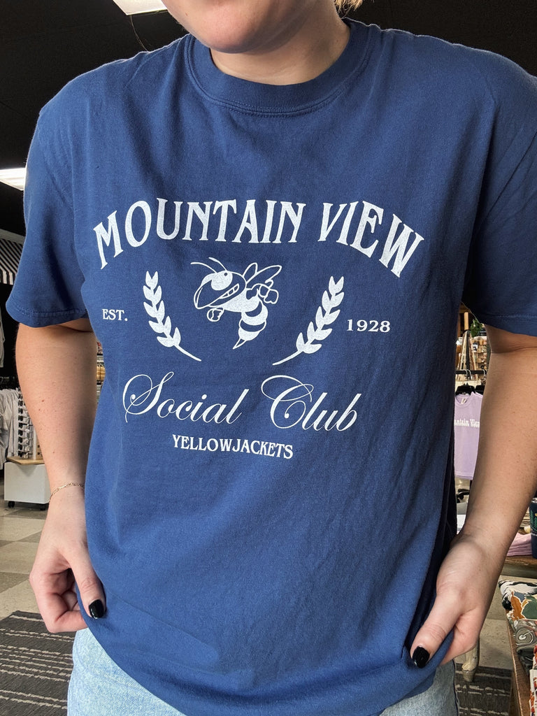 Person wearing a blue t-shirt with 'Mountain View Social Club' design