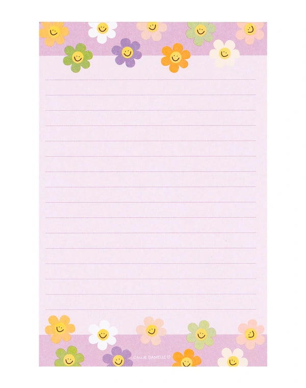 Notepad with colorful flower designs on a pink background