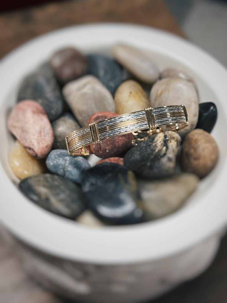 bracelet in rocks in a cream dish