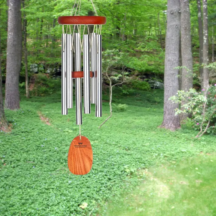 wind chime hanging with a back yard in the background