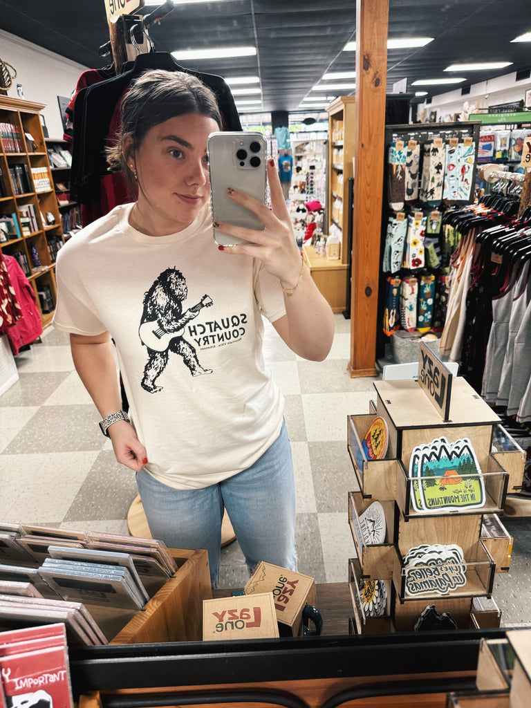 squatch country tee being worn in a store