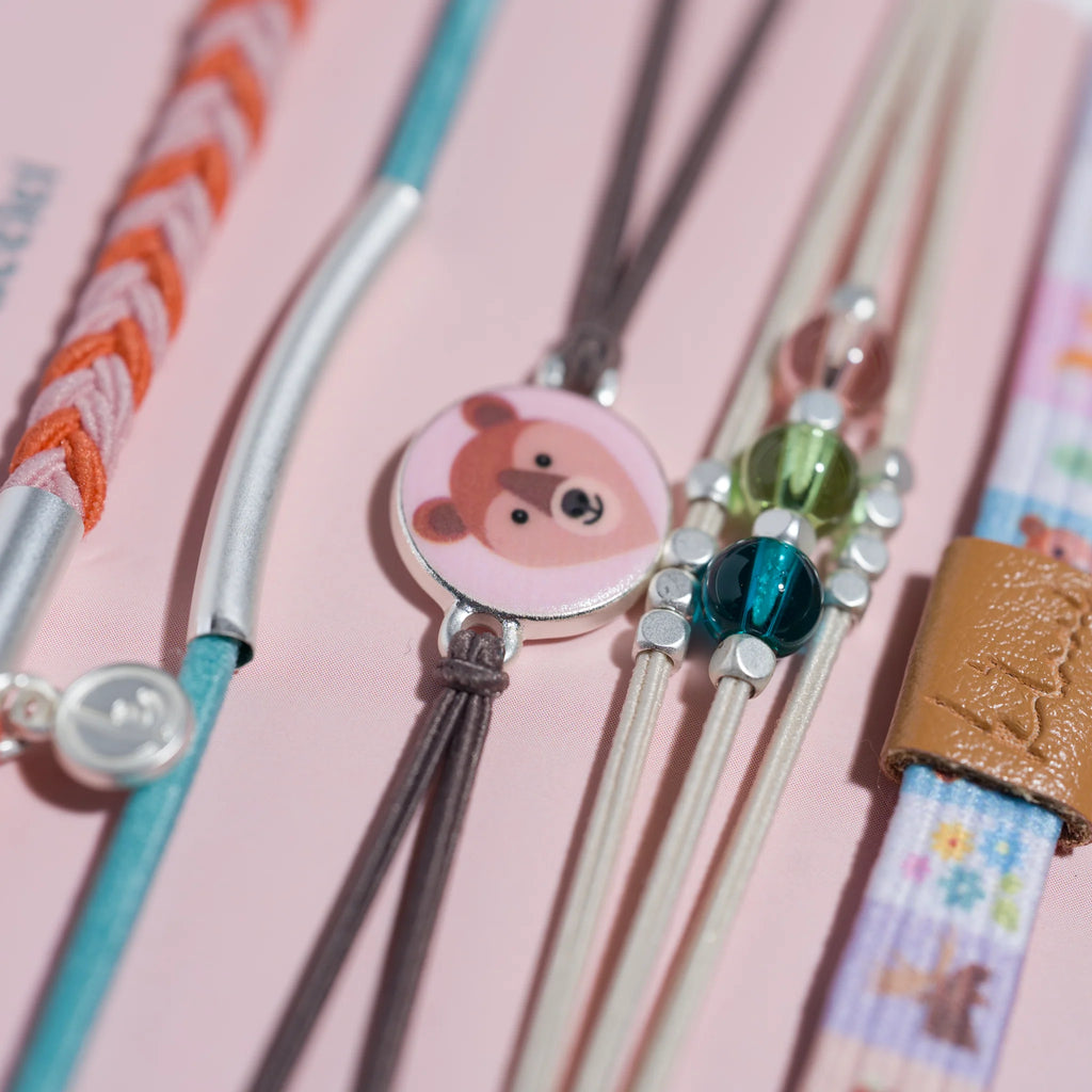 Set of colorful straws with decorative ends on a pink background
