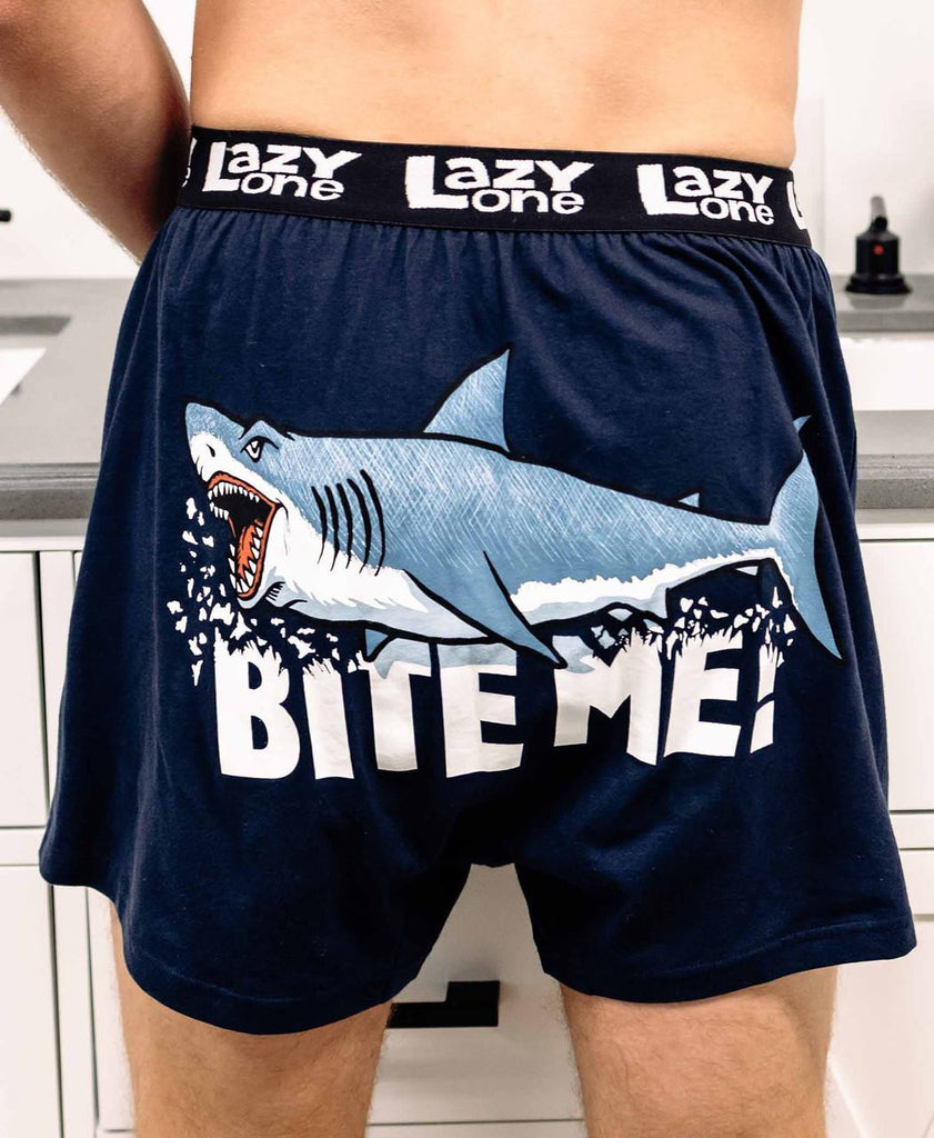 Navy blue shorts with shark graphic and 'Bite Me!' text, brand 'Lazy One' visible.