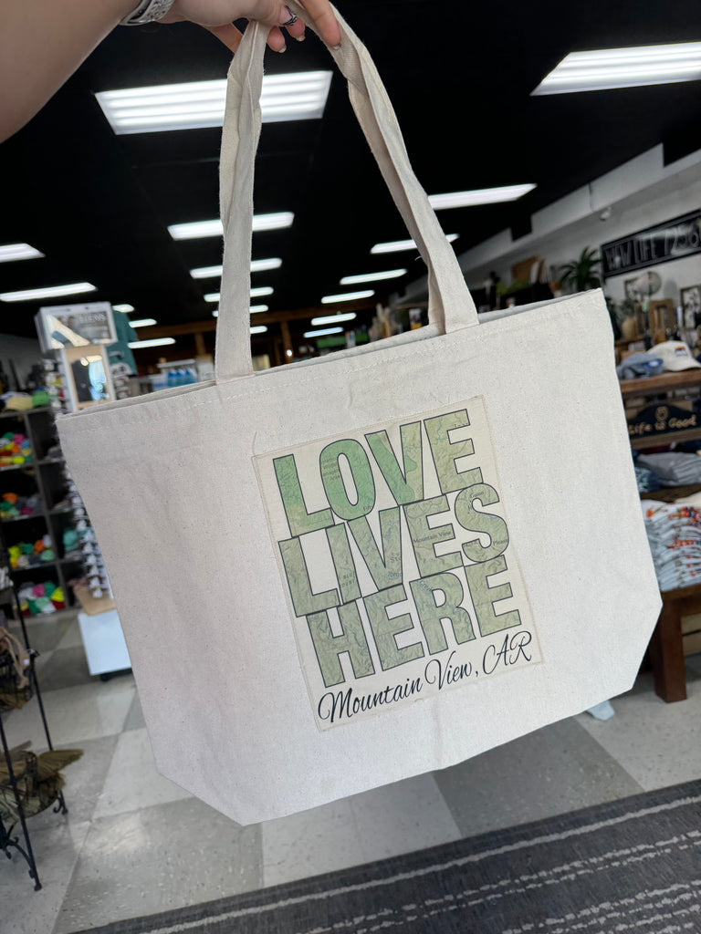 love lives here tote in a store