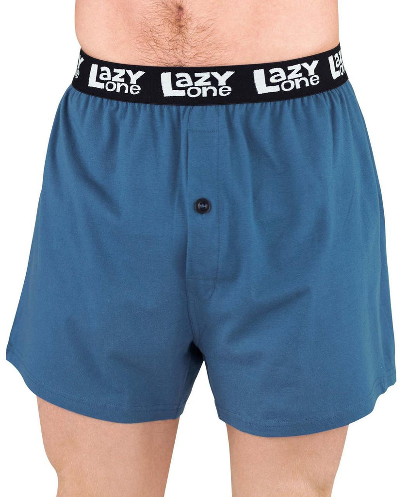 Blue boxer shorts with a black waistband featuring 'Lazy One' branding on a white background.
