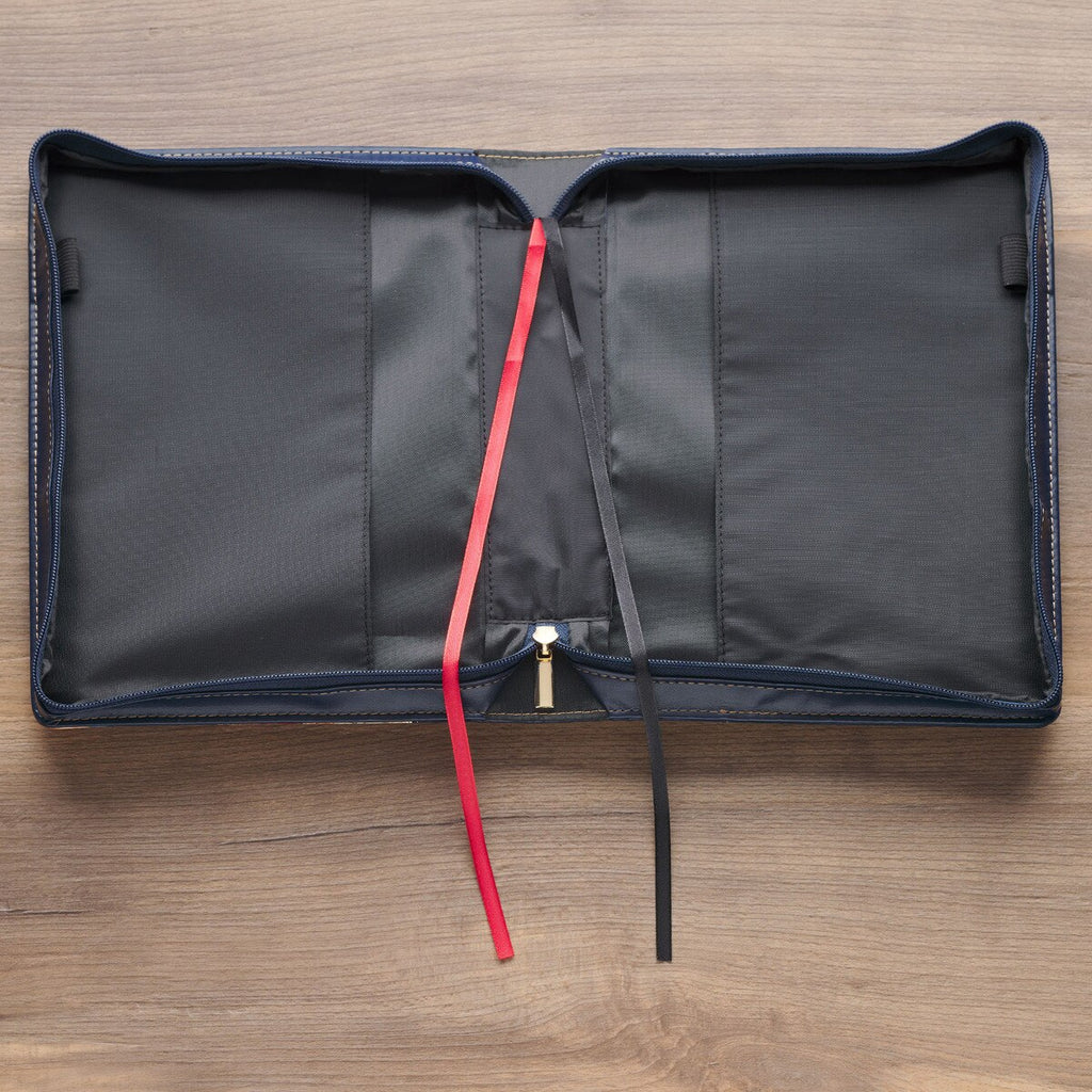 Black pouch with a red drawstring on a wooden surface