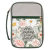 Floral-patterned pouch with 'He restores my soul' text on a gray background