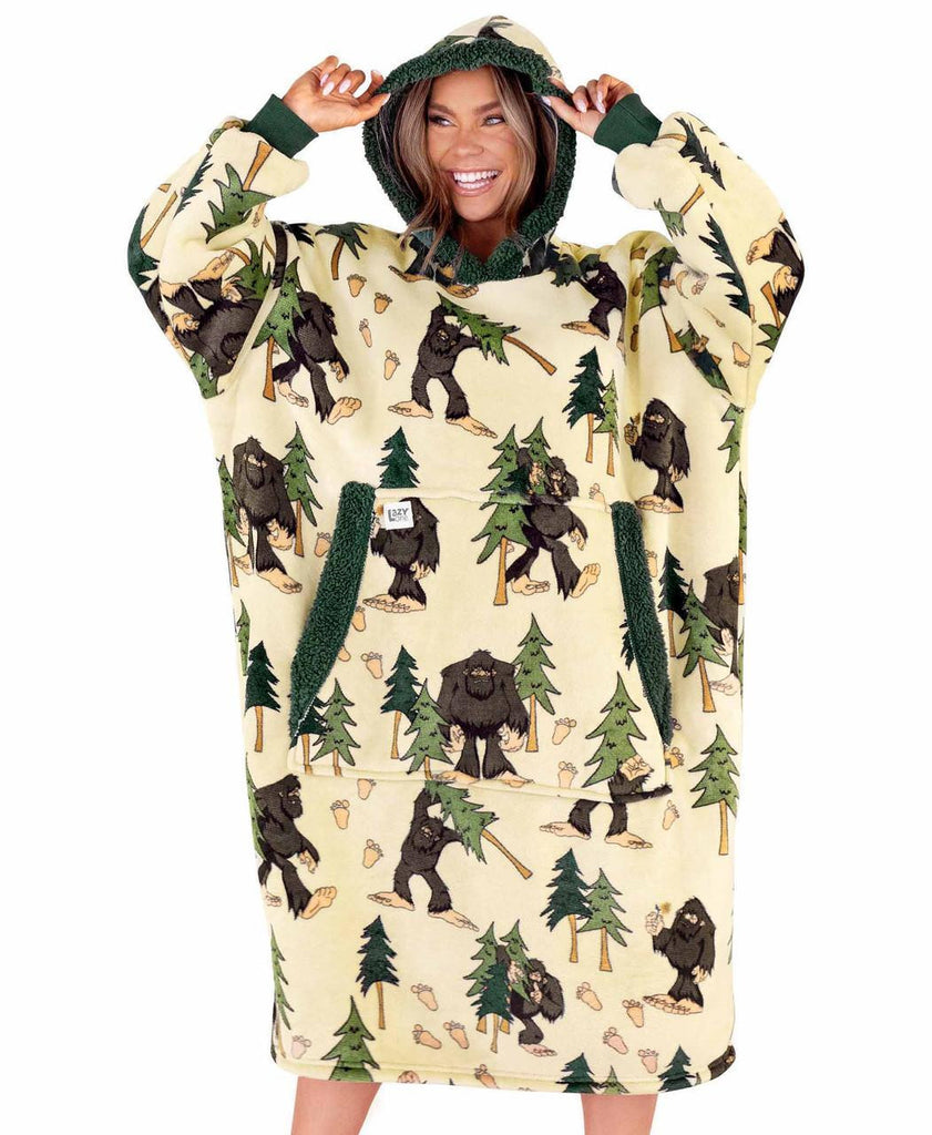 Person wearing a hoodie with bear and tree pattern on a white background