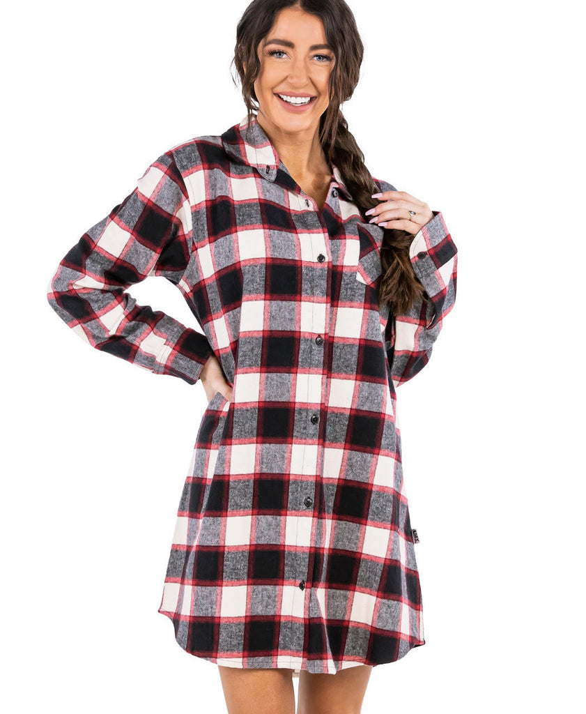 Woman wearing a black and red plaid shirt dress on a white background