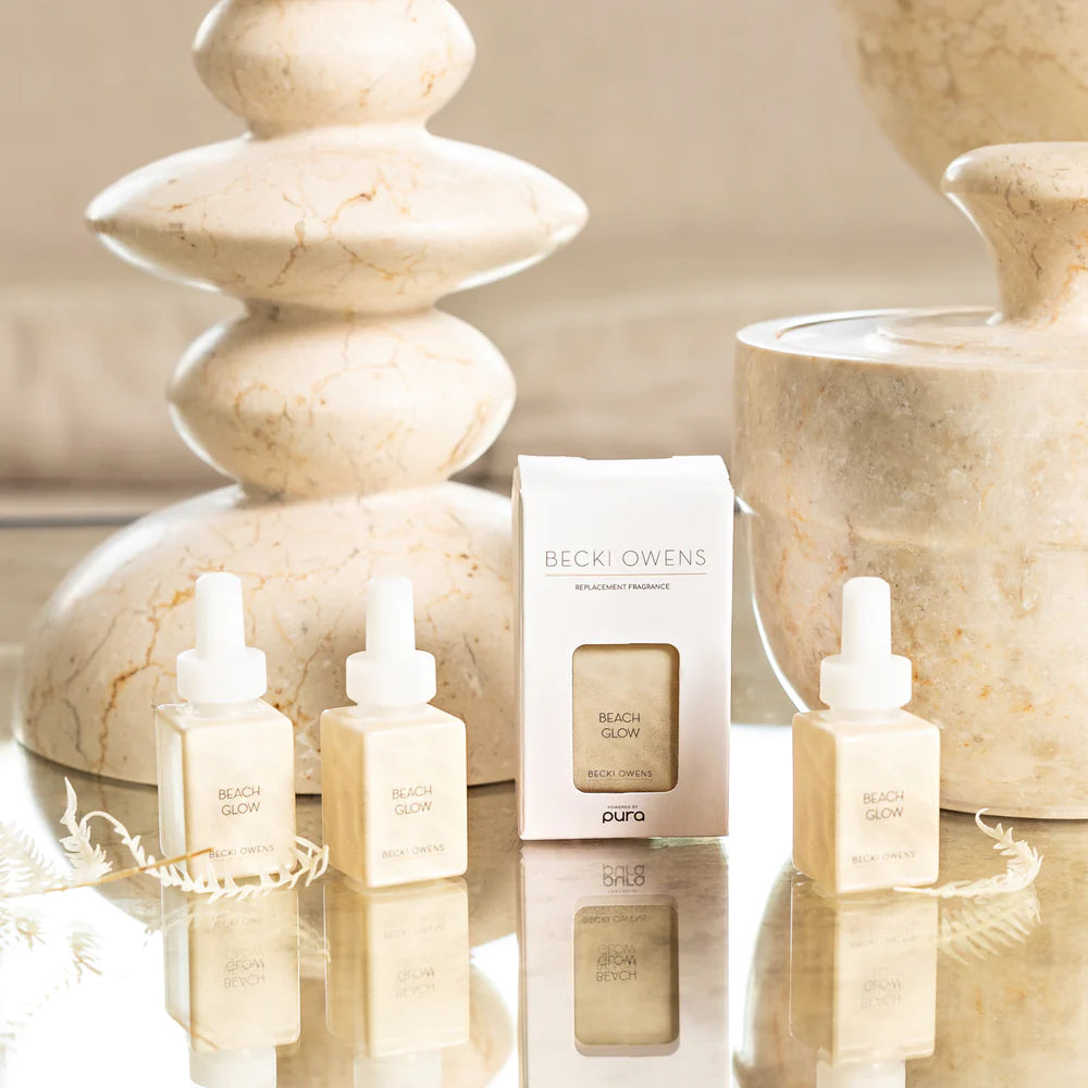 Becki owens diffuser oils setting on a table with decorative marble stone items