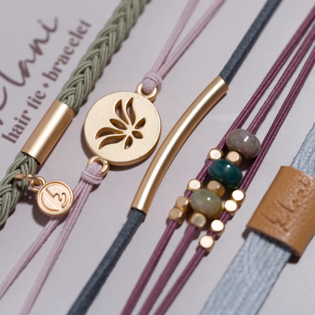 Collection of colorful bracelets with various designs on a light gray background