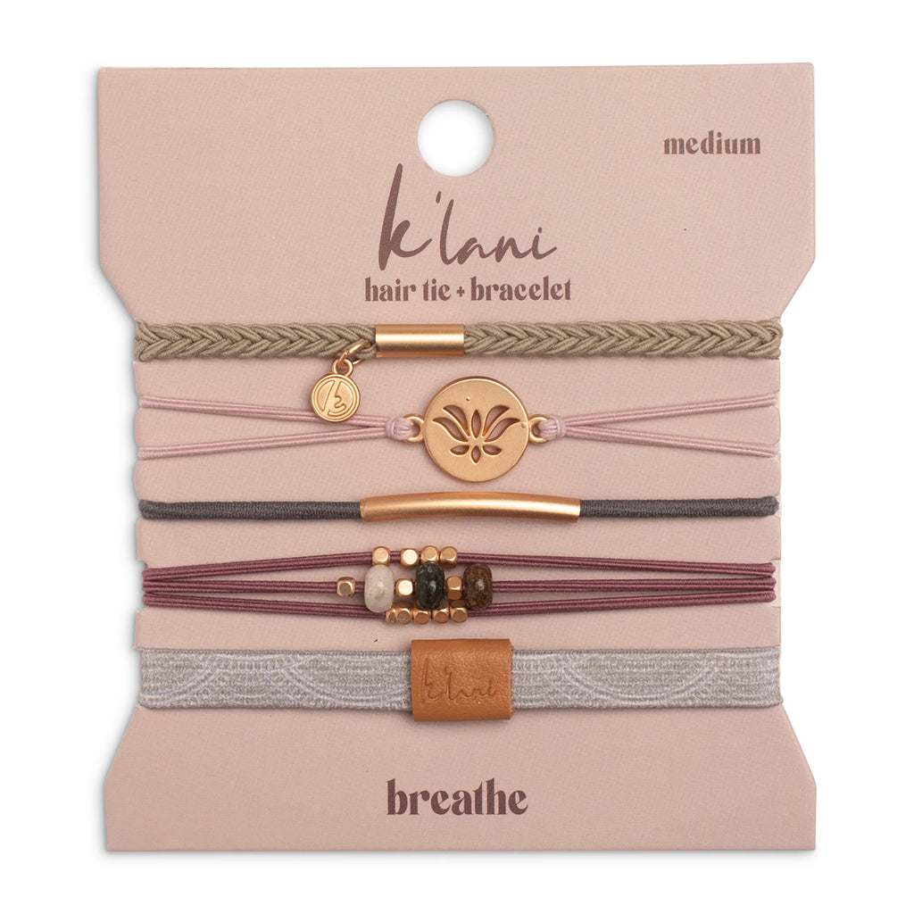 Set of hair ties and bracelets on a 'klani' branded card with 'breathe' text.