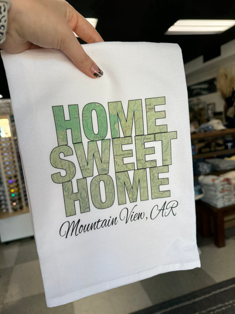 home is where our story begins towel in a store