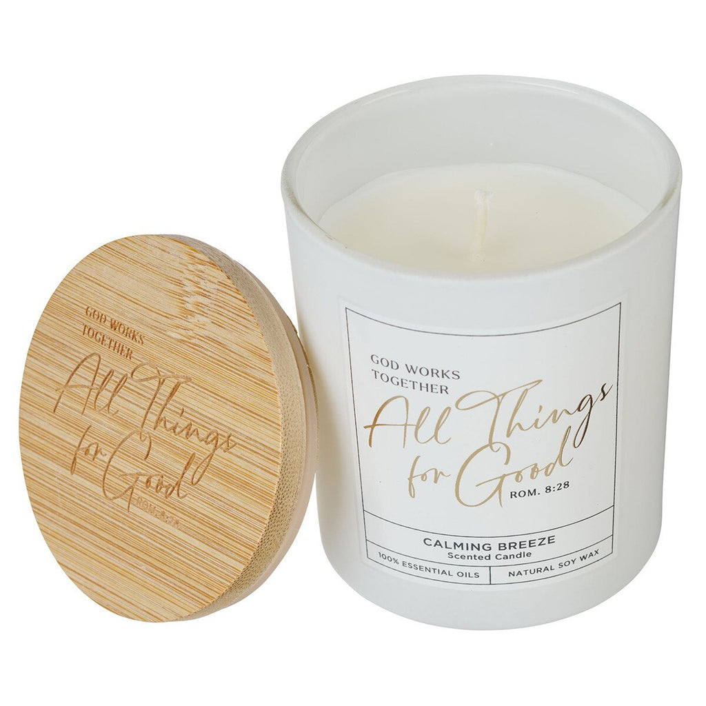 Candle with wooden lid and 'All Things for Good' label on a white background