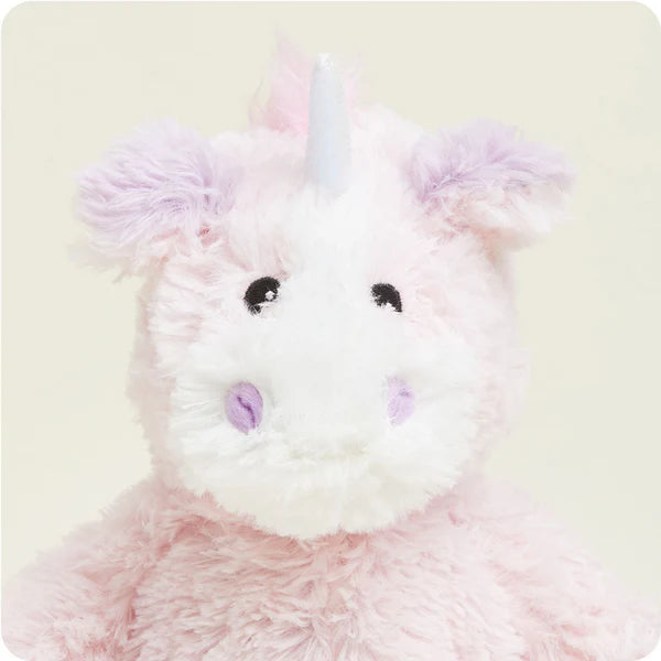 Plush unicorn toy with pastel colors on a light background