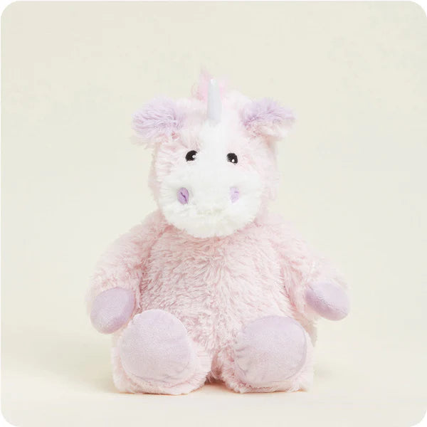 Plush unicorn toy on a light beige background