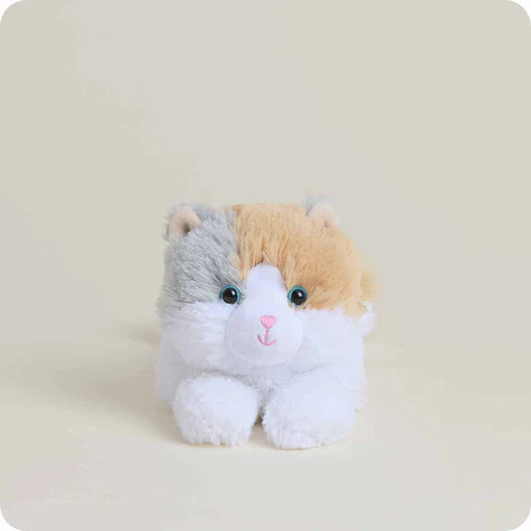 Plush toy cat with a white chest and multicolored body on a beige background