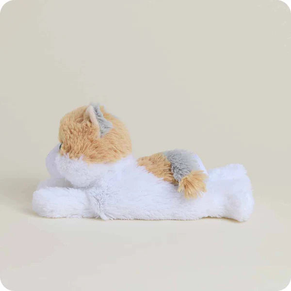 Plush toy resembling a cat on a light beige background