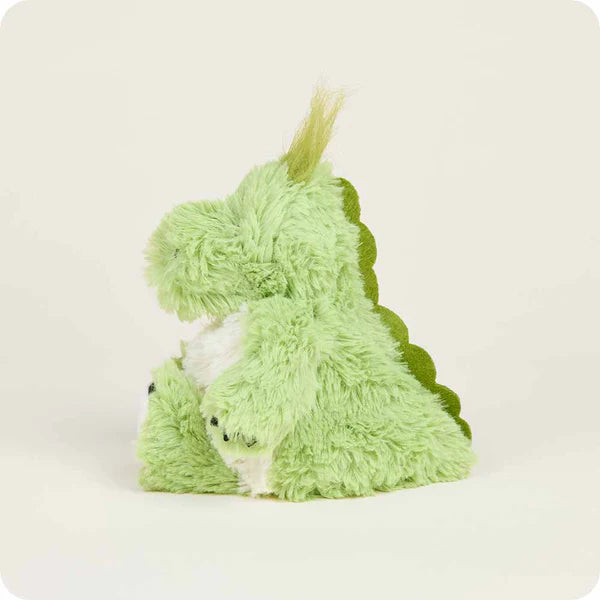 Green plush toy resembling a dinosaur on a white background