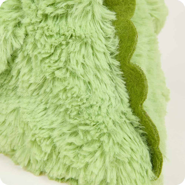 Close-up of a green textured fabric with wavy edge on a white background