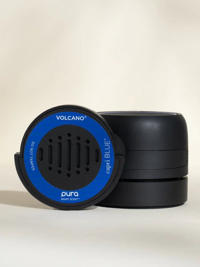 Pura Volcano car fragrance refill with the car diffuser device on a beige background