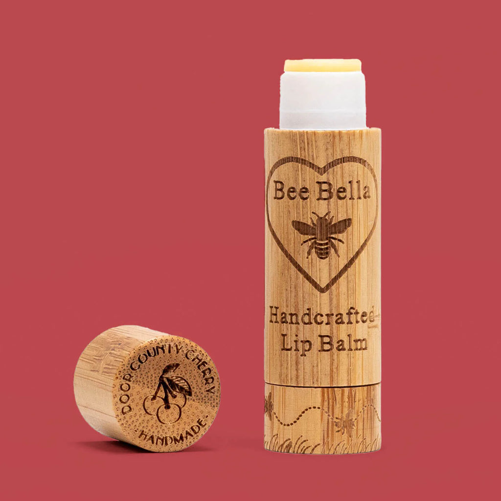 Bee Bella lip balm with wooden container on a red background