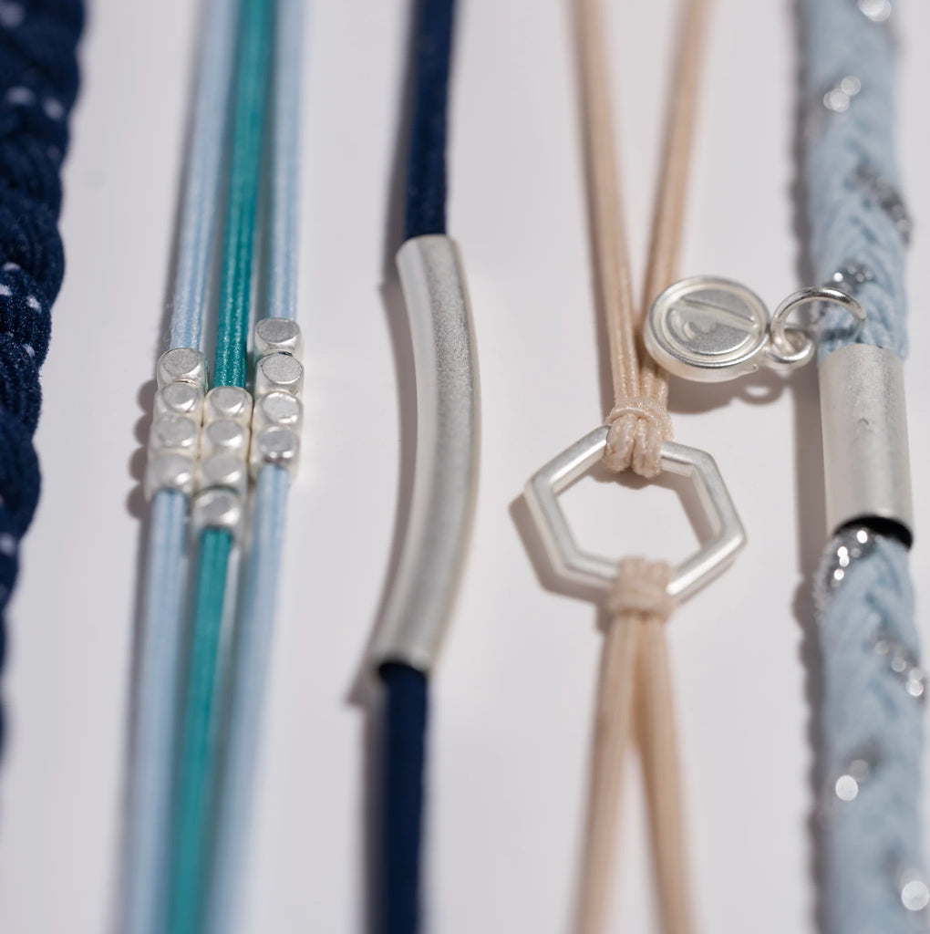 Close-up of colorful hair ties with decorative ends on a white background