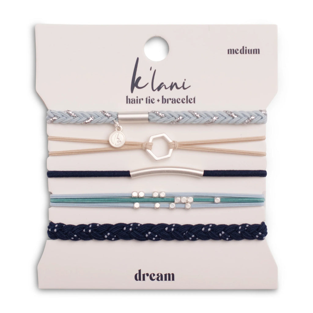 Set of hair ties and bracelets on a 'klani' branded card with 'dream' text.