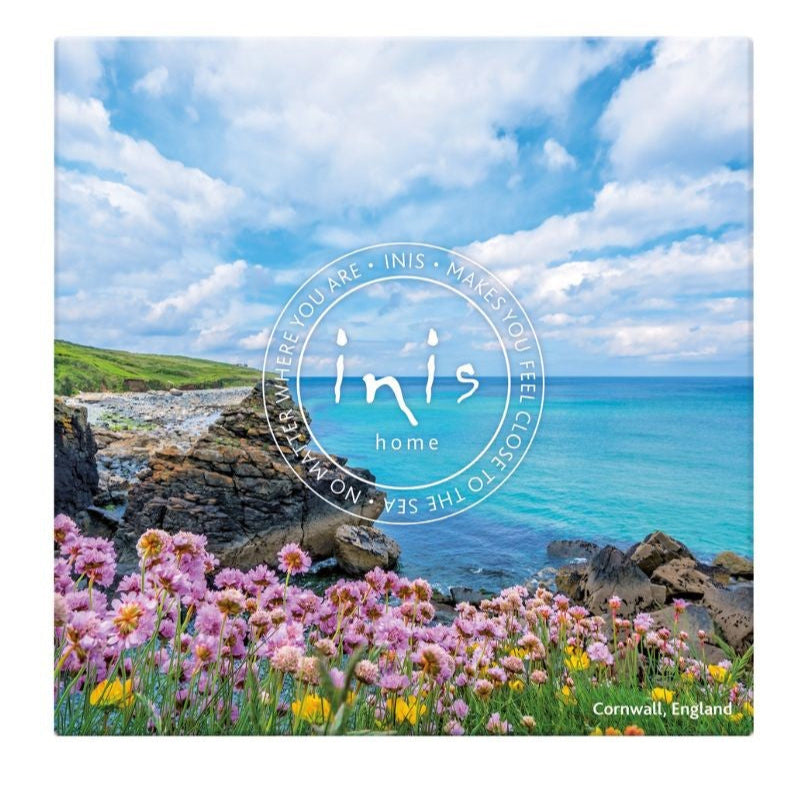 Product packaging with scenic view of ocean and flowers, featuring the brand 'Inis'.