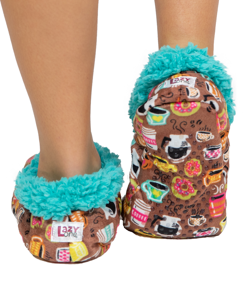 Pair of colorful slippers with a pattern of coffee cups and donuts, featuring turquoise fur trim, on a white background.