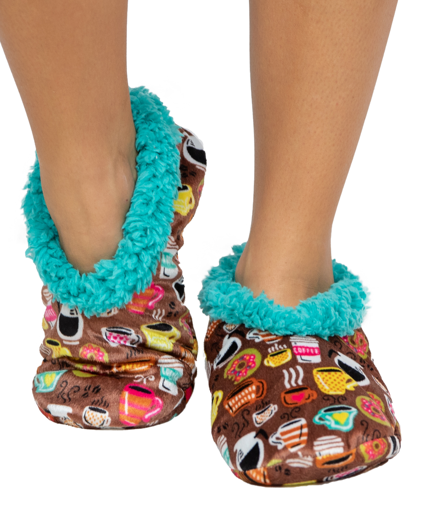 Colorful slippers with turquoise fuzzy trim worn by a person on a white background