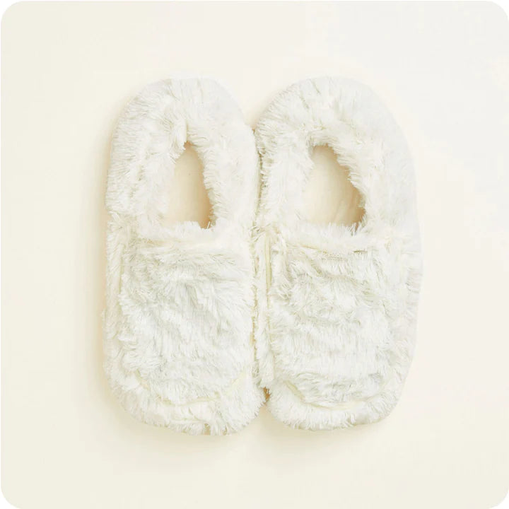 warmies cream slippers on a cream background