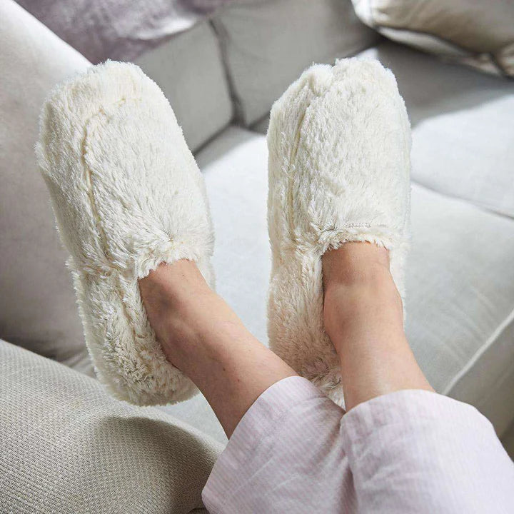 warmies cream slippers on a cream background