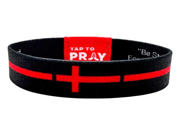 Black wristband with red cross and text on a white background