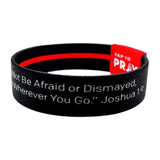 Black wristband with red interior and inspirational quote on a white background