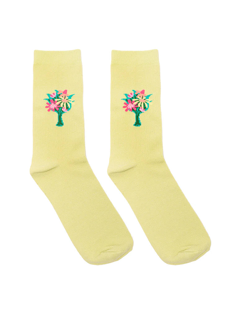 Pair of light yellow socks with floral designs on a white background