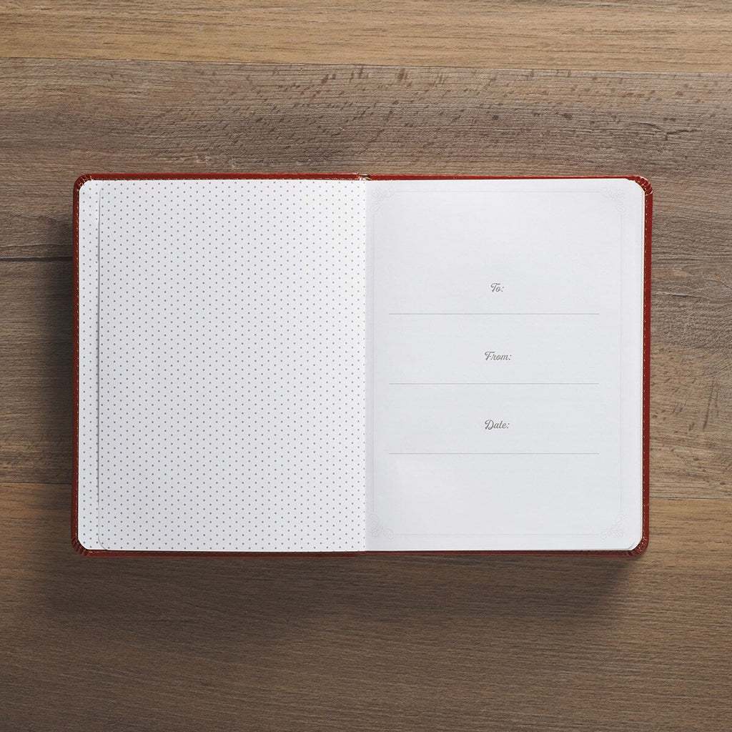 Open notebook with grid and dot pages on a wooden surface