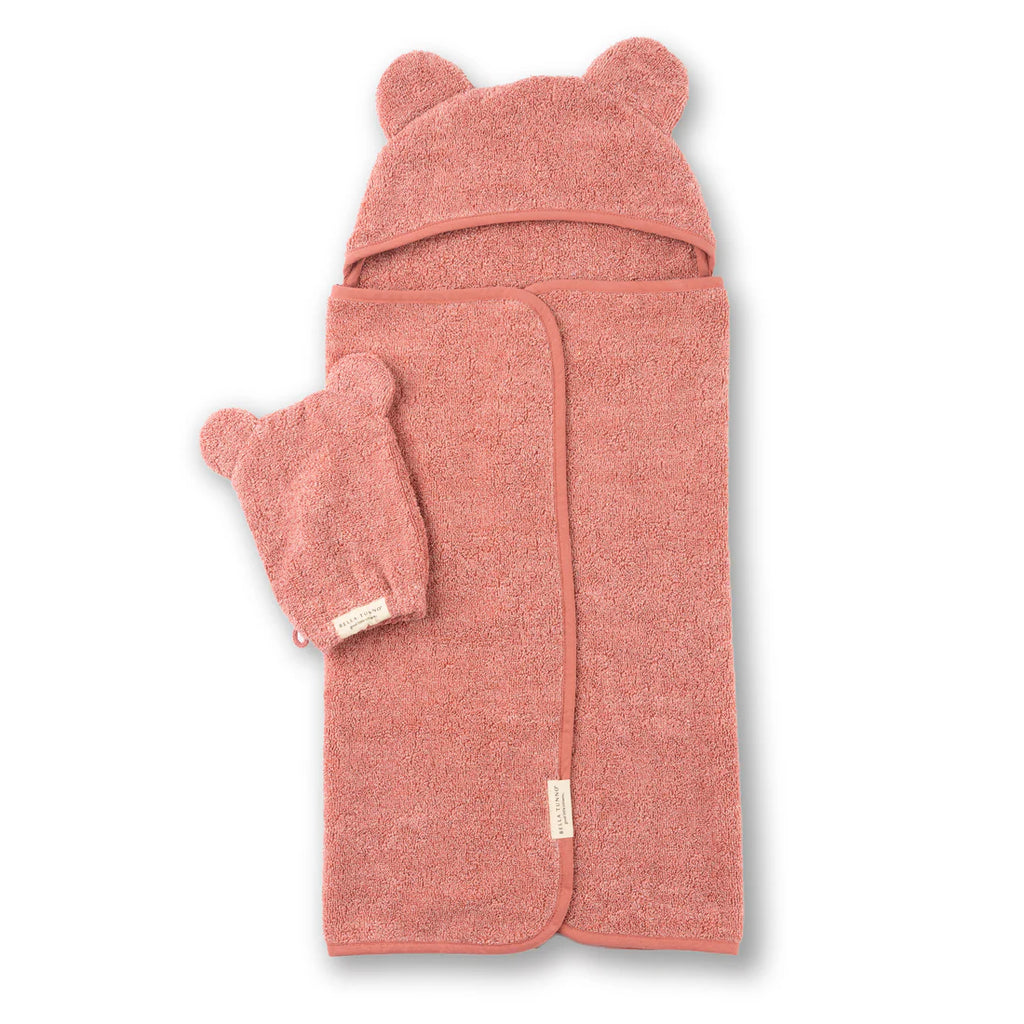 Pink hooded towel with bear ears and matching hat on a white background