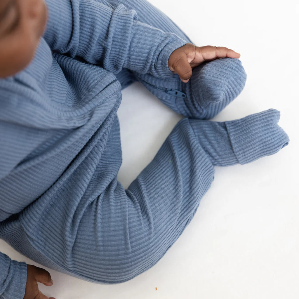 Blue ribbed sweater on a white background