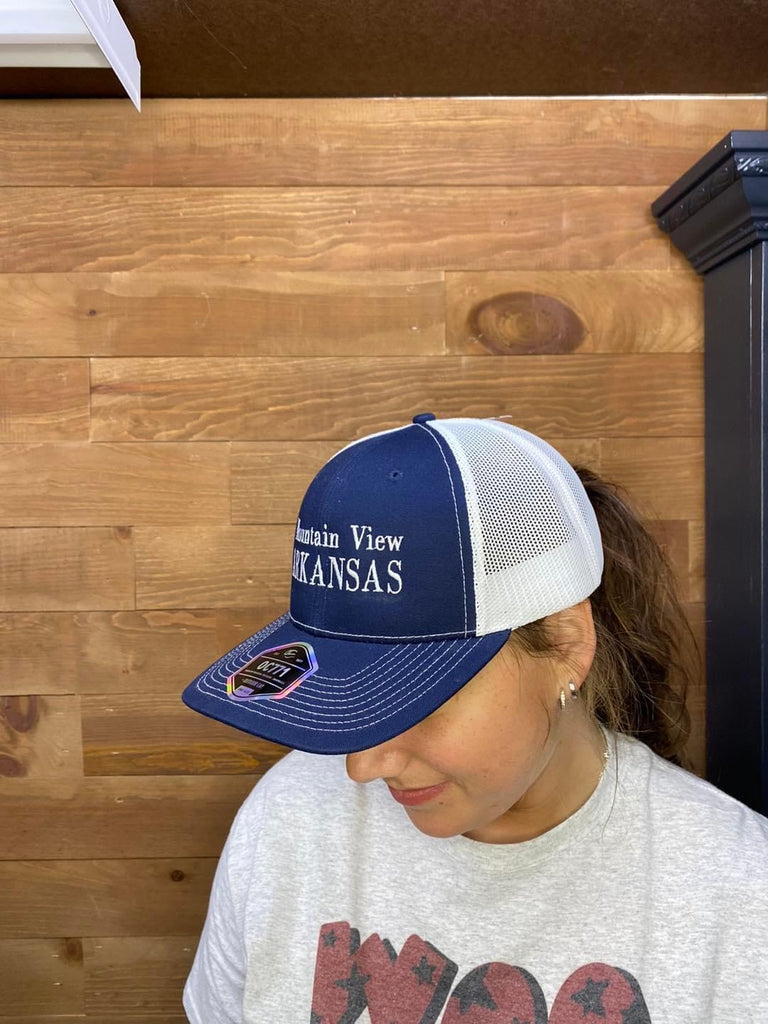 mountain view arkansas hat being worn in front of a wood wall