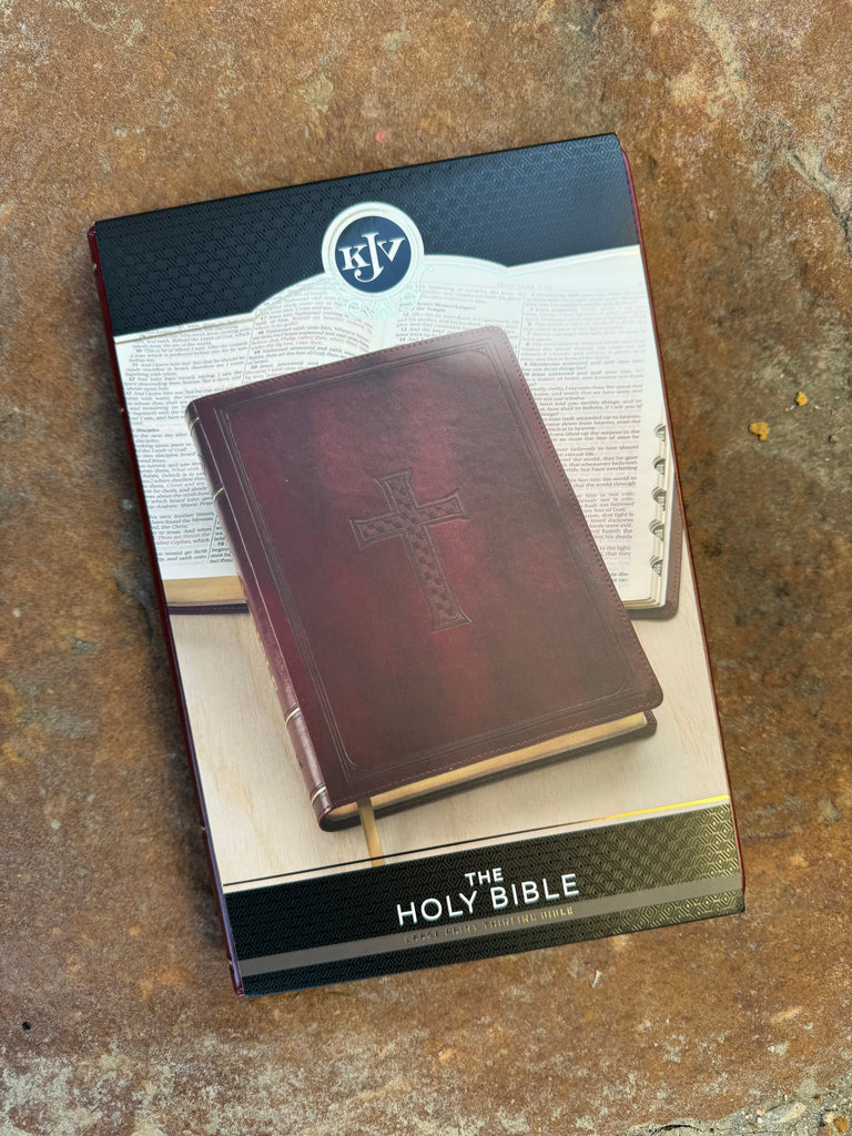 KJV Embossed Cross Burgundy Bible on a brown background