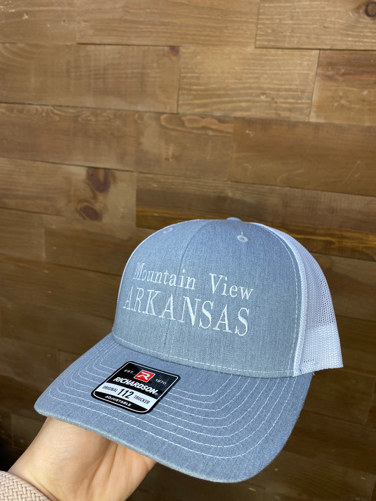 mountain view arkansas hat being worn in front of a wood wall