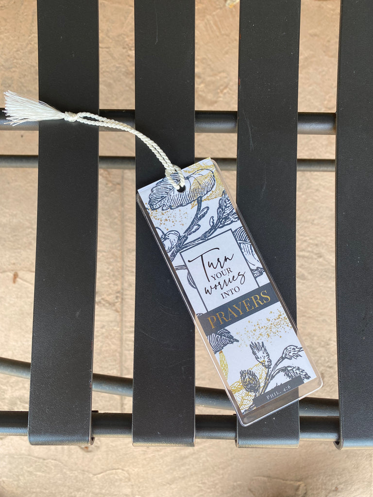 turn your worries bookmark on a black metal bench
